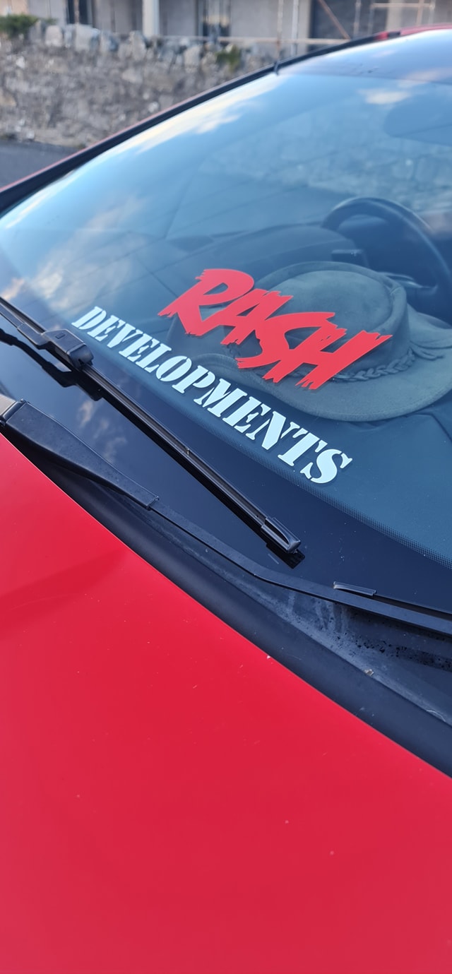 Rash Developments windscreen decal on a red car