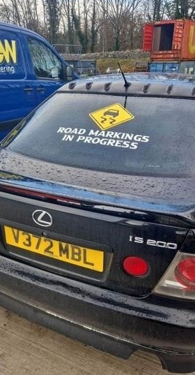 Road markings in progress decal on black car